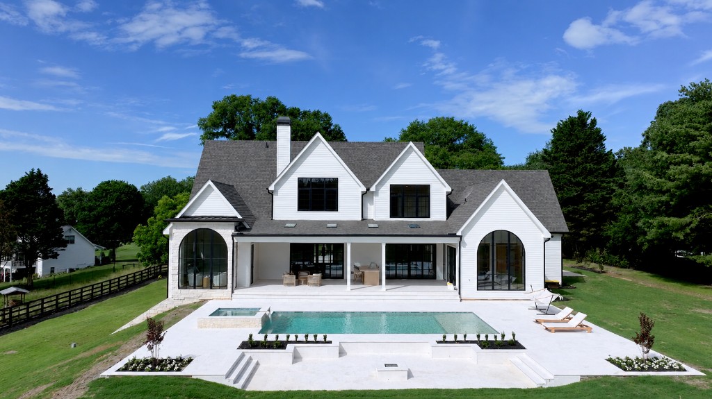 Aerial view of a luxury residence with pool and landscaped grounds